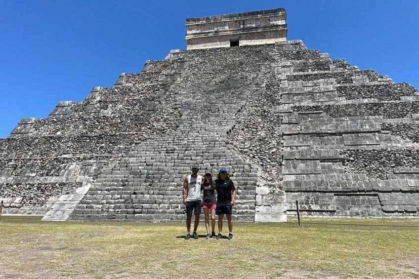 A large pyramid structure with a flat top and a staircase leading up to it. 3