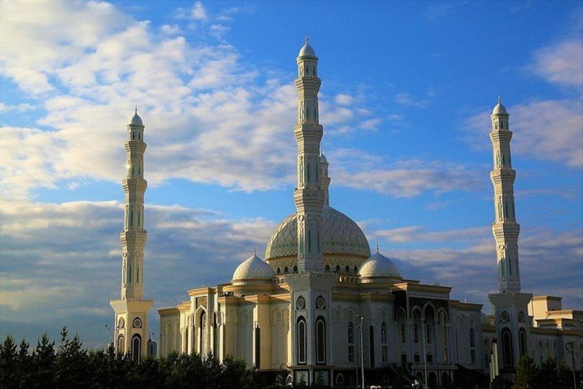 A mosque with two minarets and a large dome. 1