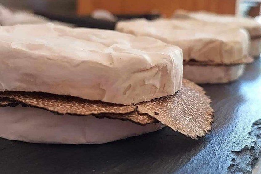 A sandwich with a textured bread and a piece of meat. 2