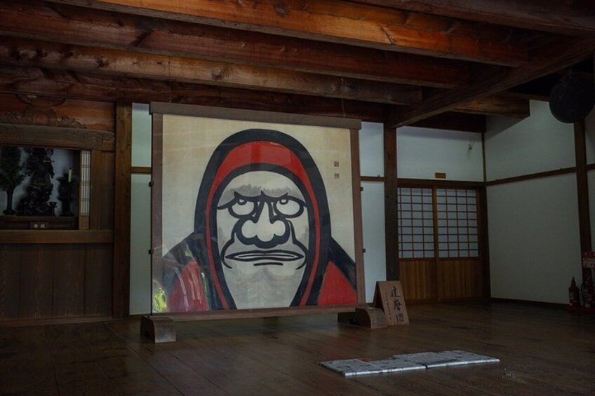 A wooden interior with a large framed artwork on the wall. 3