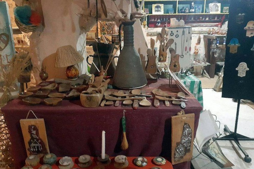 A table with various pottery items, including bowls, plates, and a large vase. 3
