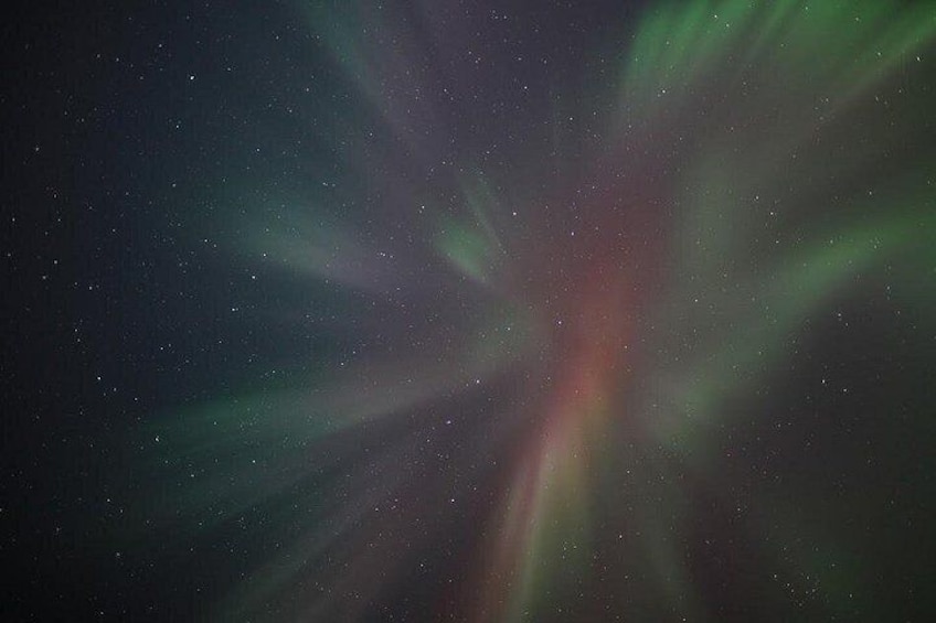 A starry night sky with visible aurora borealis. 4