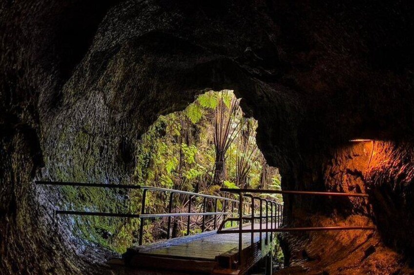 A cave entrance with a wooden platform and railing. 4