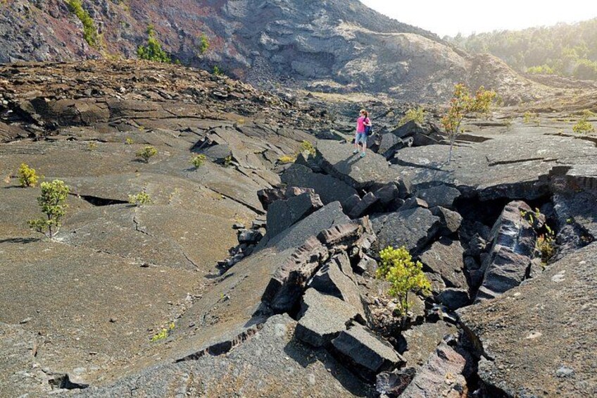 A rocky terrain with a person standing on a ledge. 5