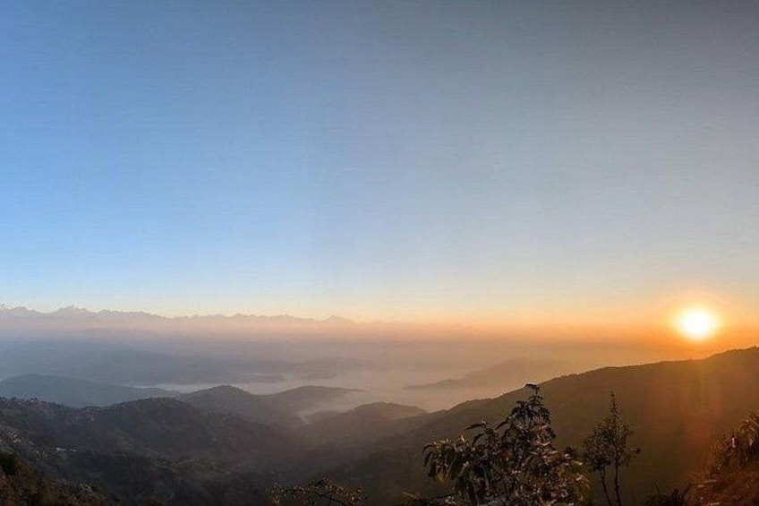A sunrise over a mountainous landscape with a clear sky. 1