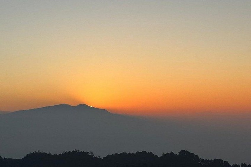 A mountain silhouette against a sunset sky. 3