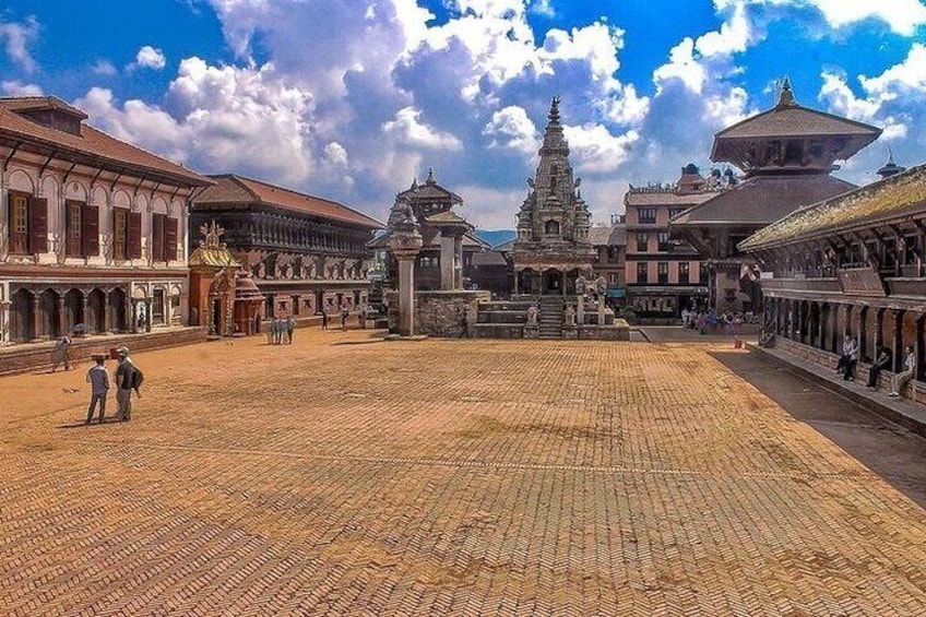 A historical square with traditional buildings, a central temple, and a paved ground. 3