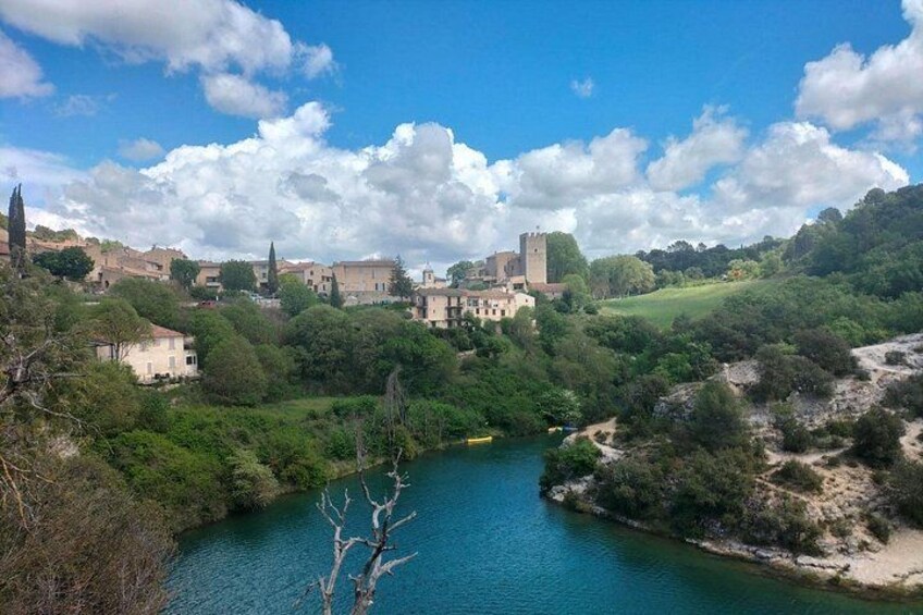 A river, a castle, and a town with buildings. 2