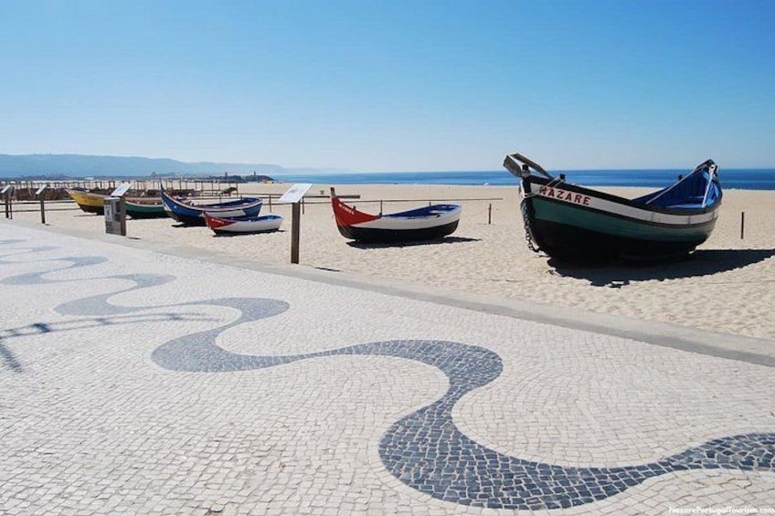 A beach with boats and a winding path. 2