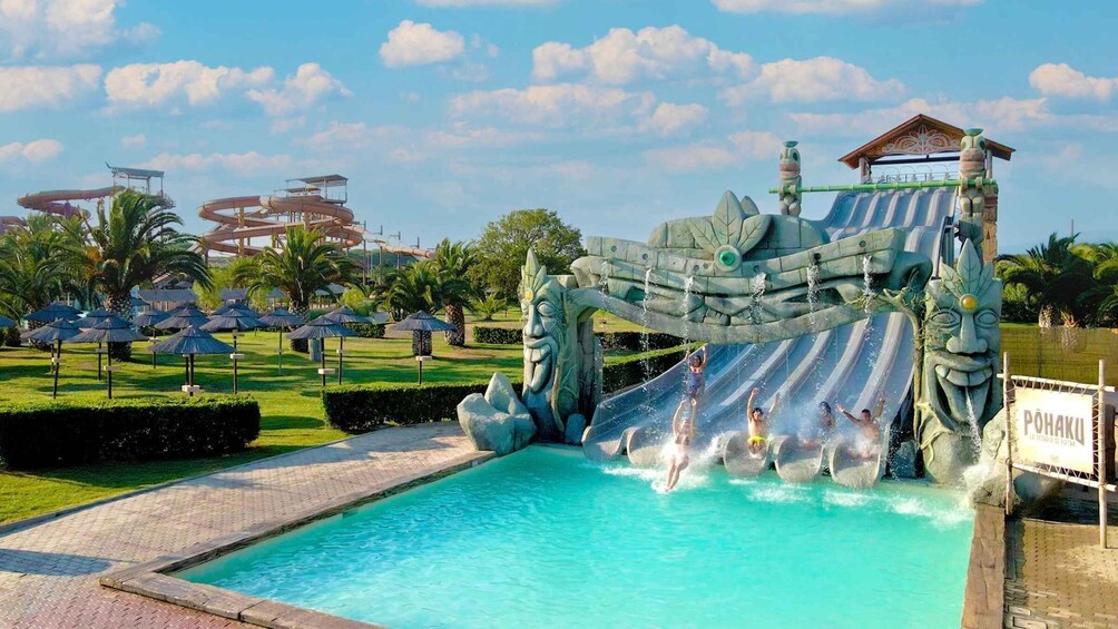 A water park with a large slide and a pool. 4
