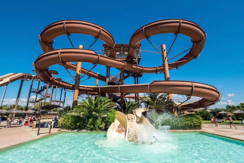 A water park with multiple slides and a pool. 1