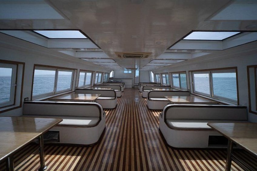 A ship's interior with rows of seating and windows. 3