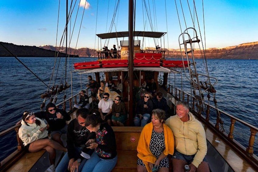 A group of people on a boat with a mountainous landscape in the background. 2