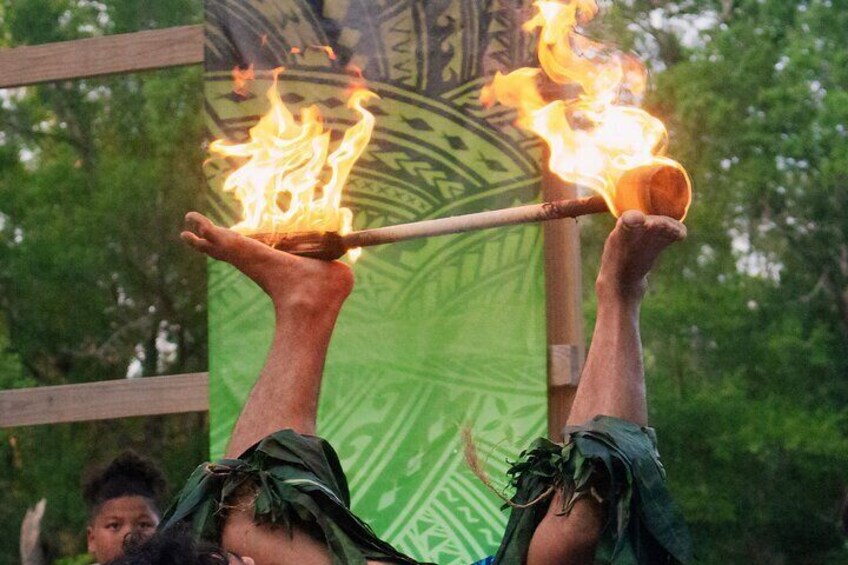 A person performing a fire juggling act with flaming torches. 1