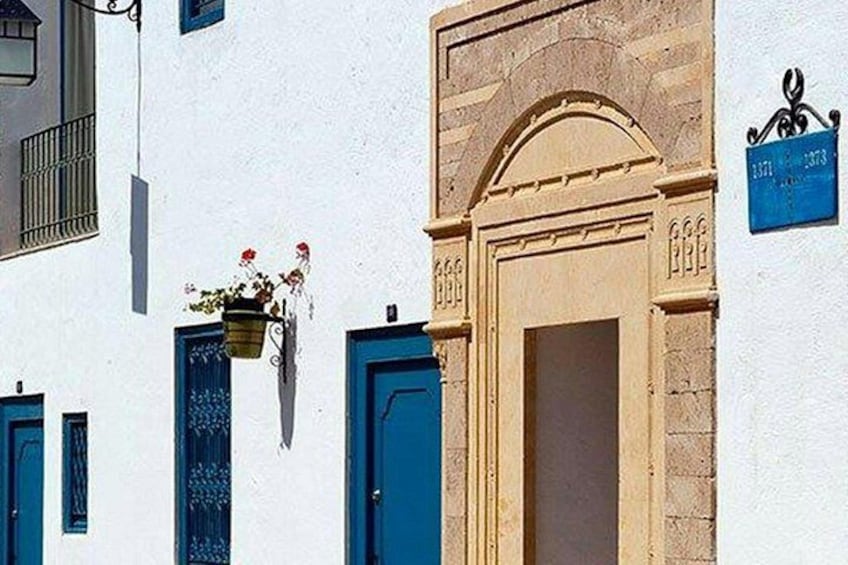 A building with a blue door and a stone archway. 4