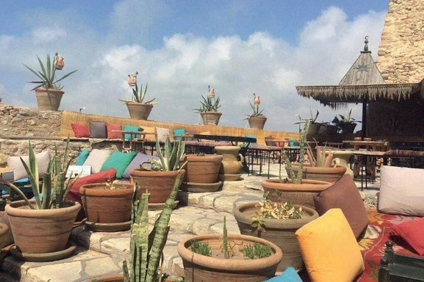 A rooftop garden with potted plants and outdoor seating. 2