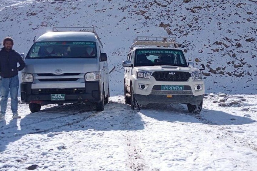 Two vehicles marked 'TOURIST ONLY' on a snowy mountain path. 3