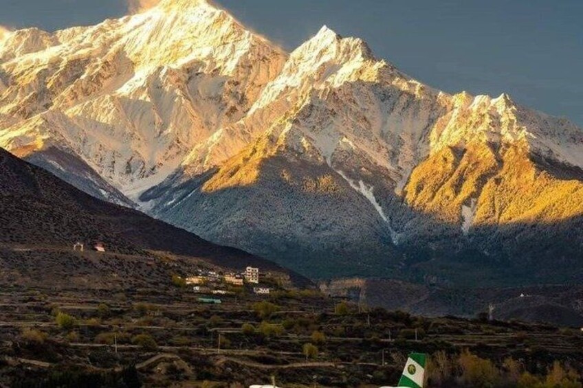 A mountain range with a village at its base. 1