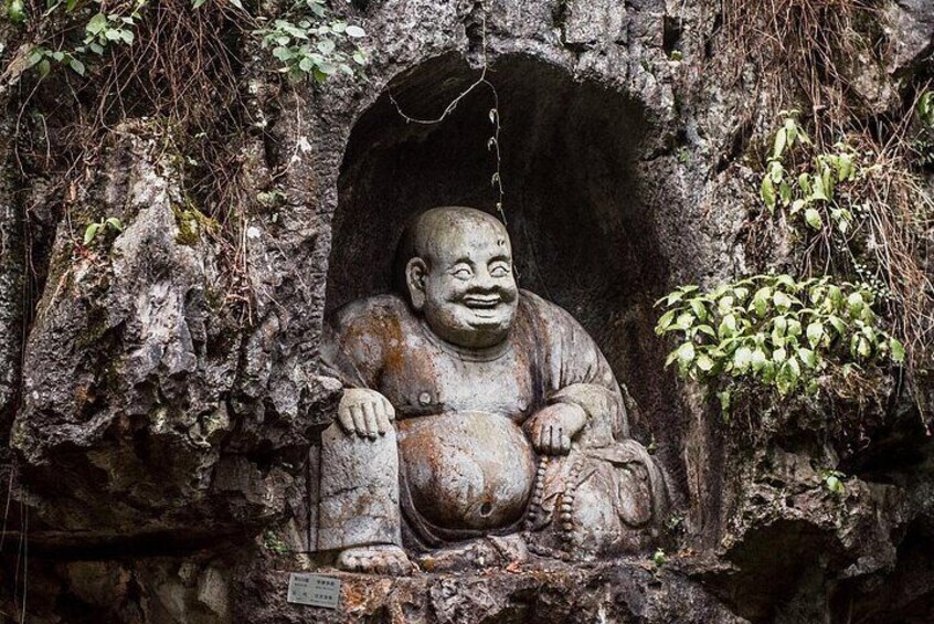 A large Buddha statue carved into a rock formation. 4