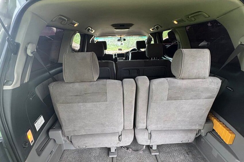 The interior of a vehicle with grey seats and a sunroof. 5