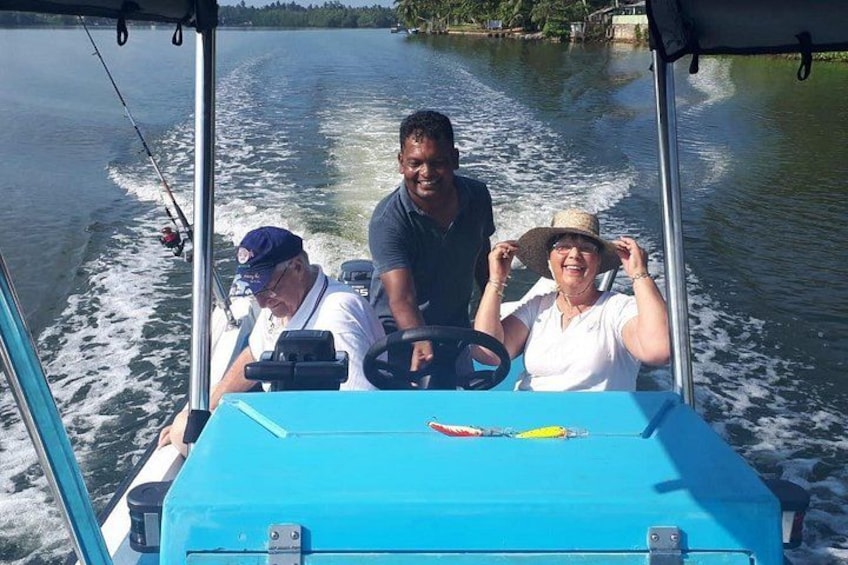 A boat with two people on board, one steering and one sitting. 3