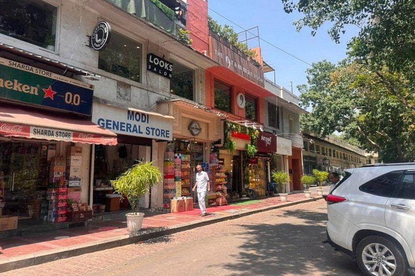 A street with shops, including a general store and a hair salon. 5