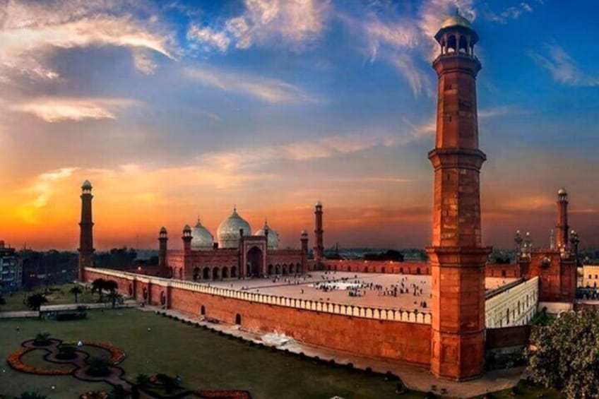 The Taj Mahal with its iconic minarets and large domes, surrounded by a large courtyard. 1