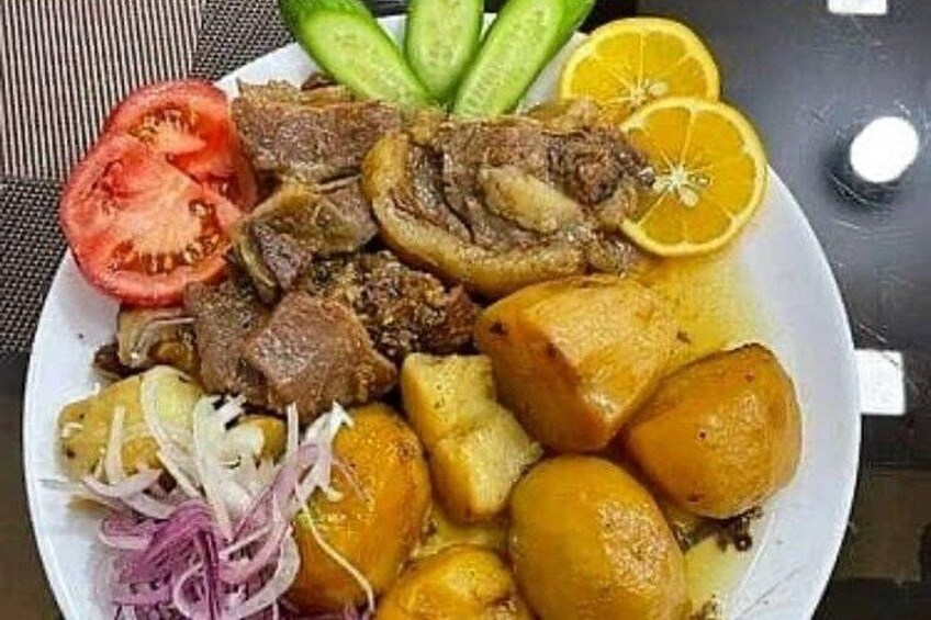 A plate of food with meat, potatoes, and vegetables. 5