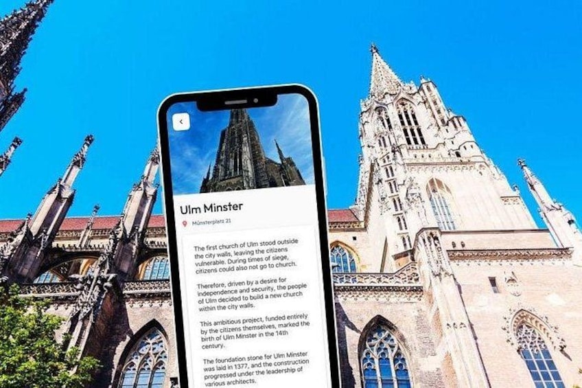 A smartphone displaying information about the Ulm Minster, with a view of the cathedral's facade. 5