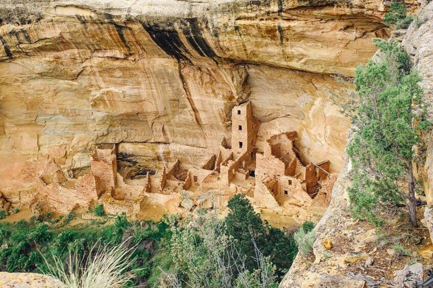 A cliffside with ancient cliff dwellings carved into the rock. 3