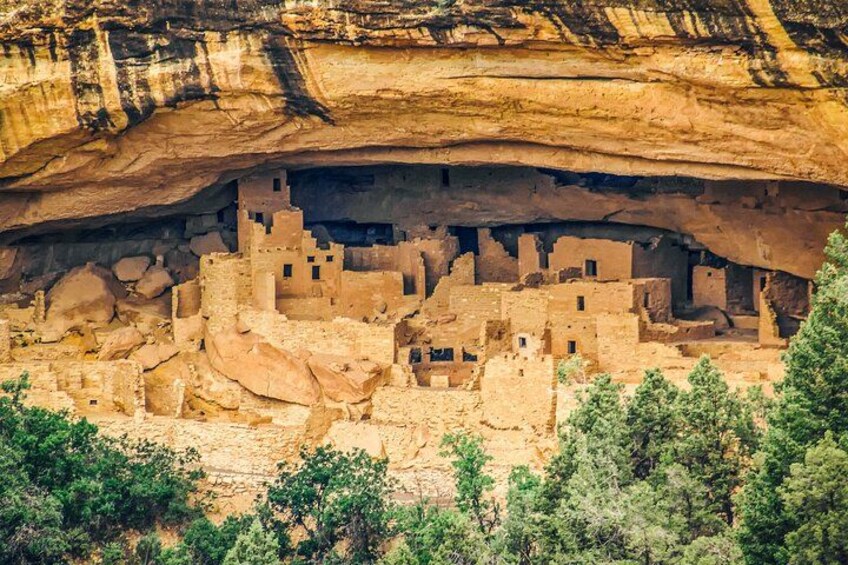 A cliffside pueblo with ancient adobe structures nestled in a canyon. 1