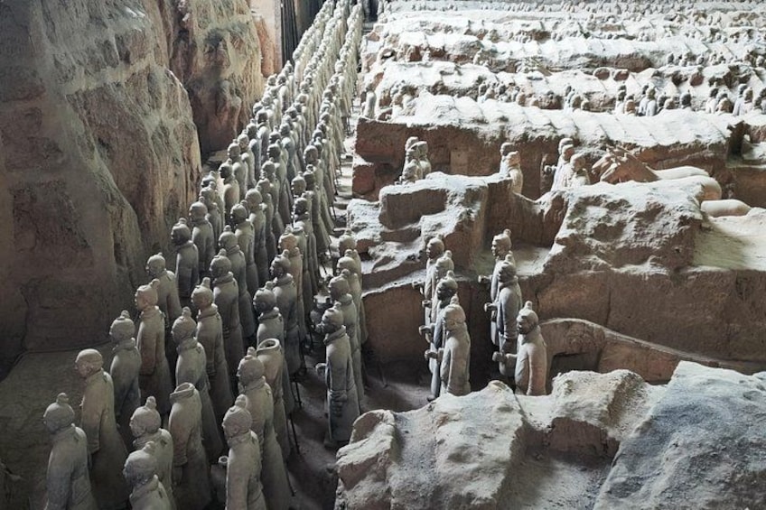 A large number of terracotta soldiers lined up in a formation. 1
