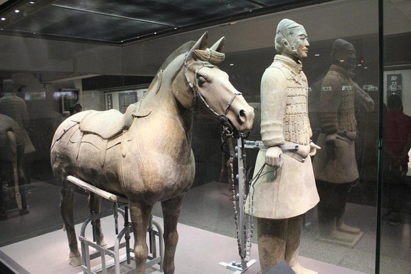 A terracotta horse and rider sculpture in a museum. 2