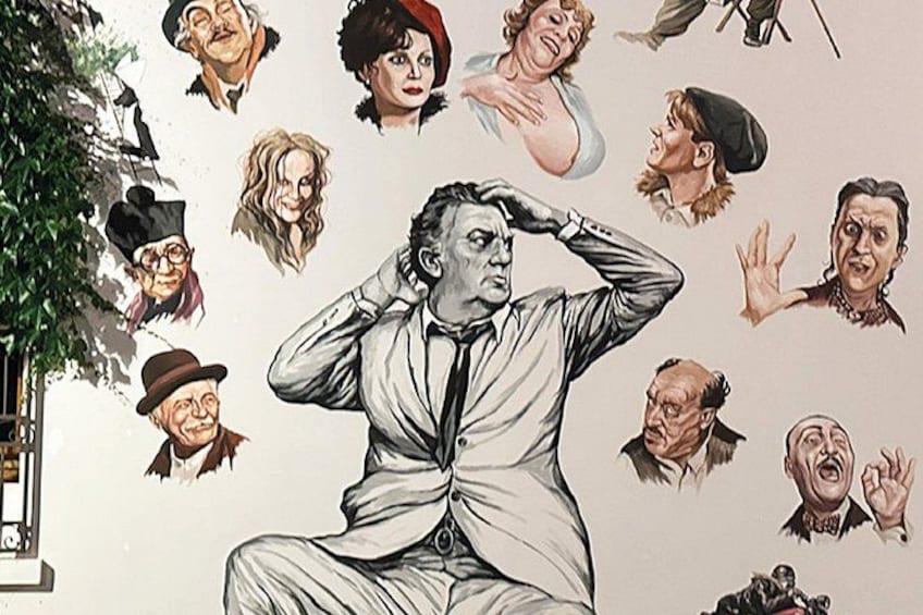 A mural with a central figure in a suit, surrounded by various other figures in different poses and expressions. 5