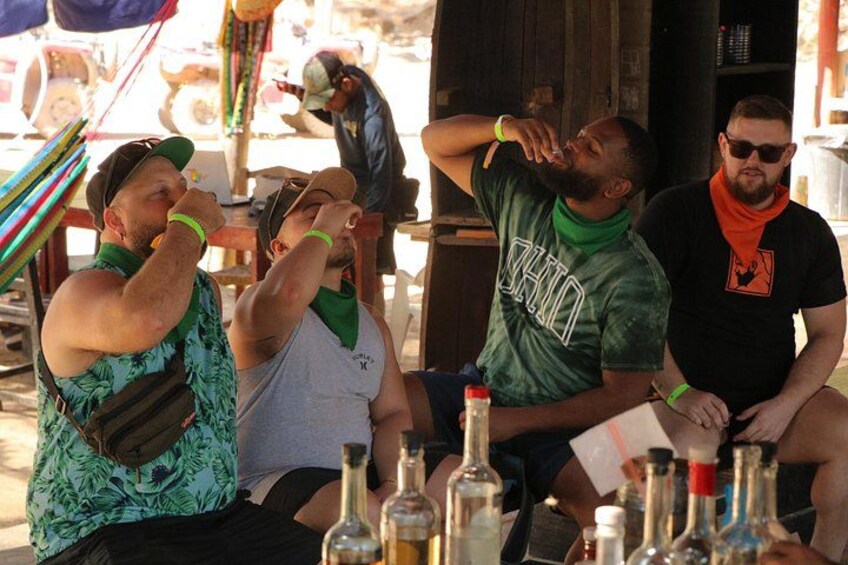 People sitting at a table with bottles. 2
