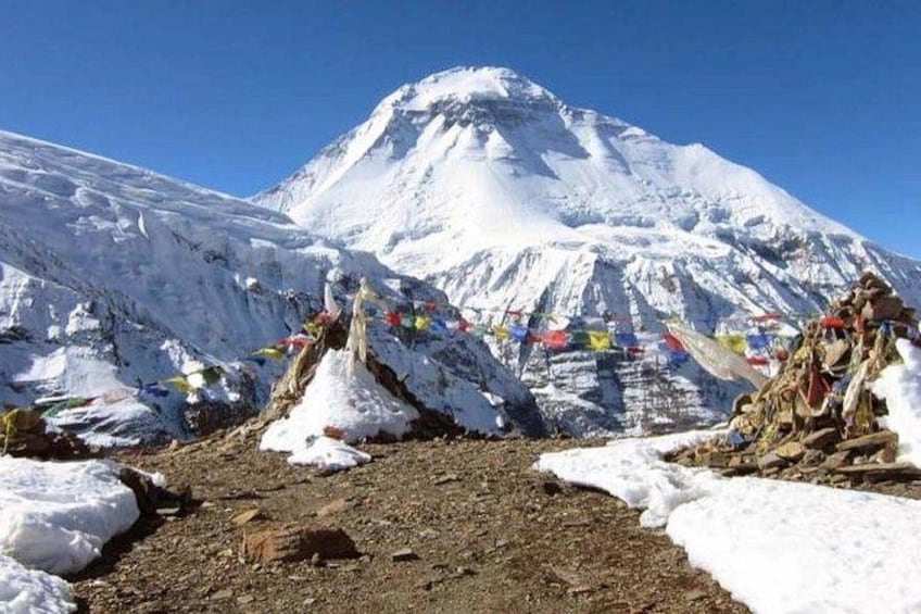 A snow-covered mountain with prayer flags. 1