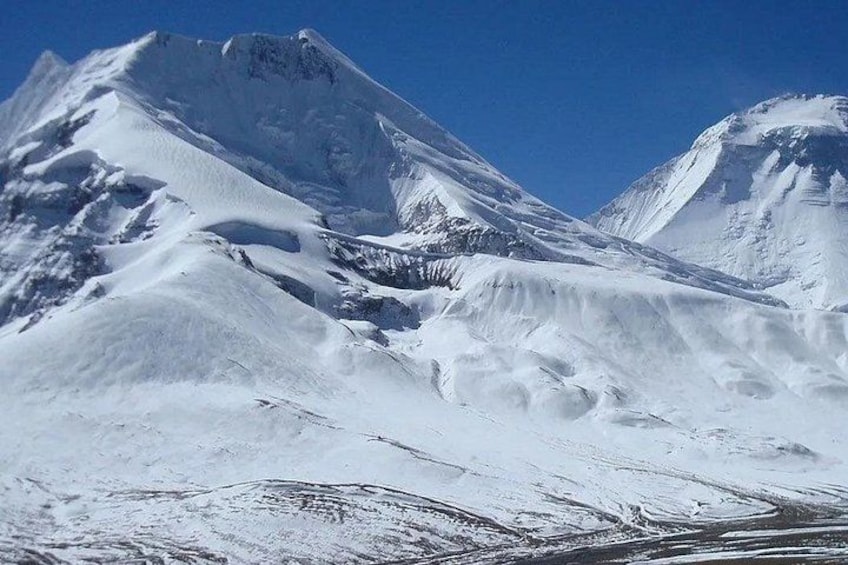 A snow-covered mountain range with sharp peaks and deep valleys. 4
