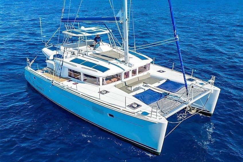 A blue sailboat on the water. 1