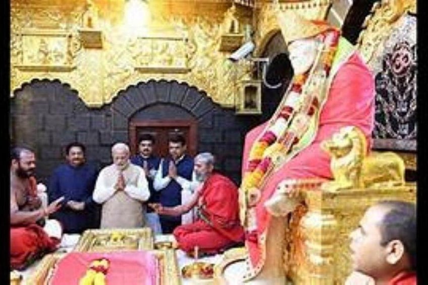 A group of people in traditional attire, a golden ornate structure, and a lion statue. 4