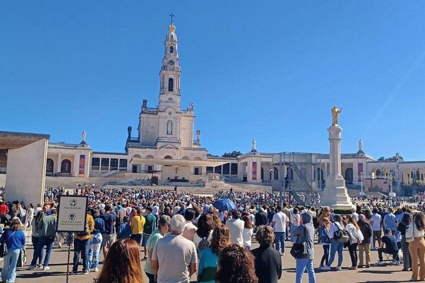 A crowded square with a prominent church and a statue. 4