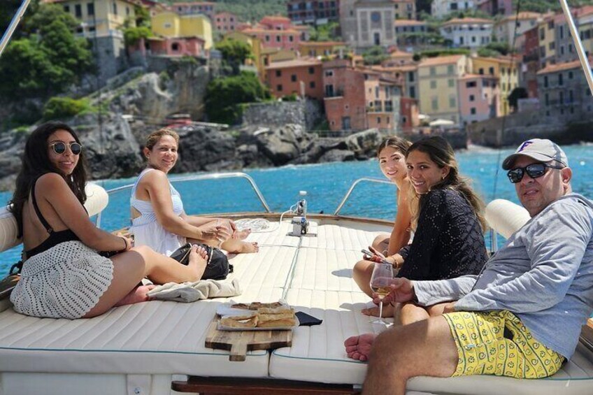 A group of people on a boat with a coastal town in the background. 5