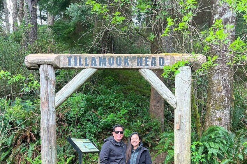 A wooden sign reading "Tillamook Head" in a forested area. 5