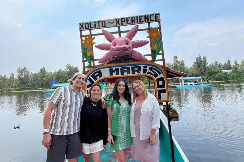 A boat with a colorful sign reading 'Xolito Experience' and 'La Marismal.' 5