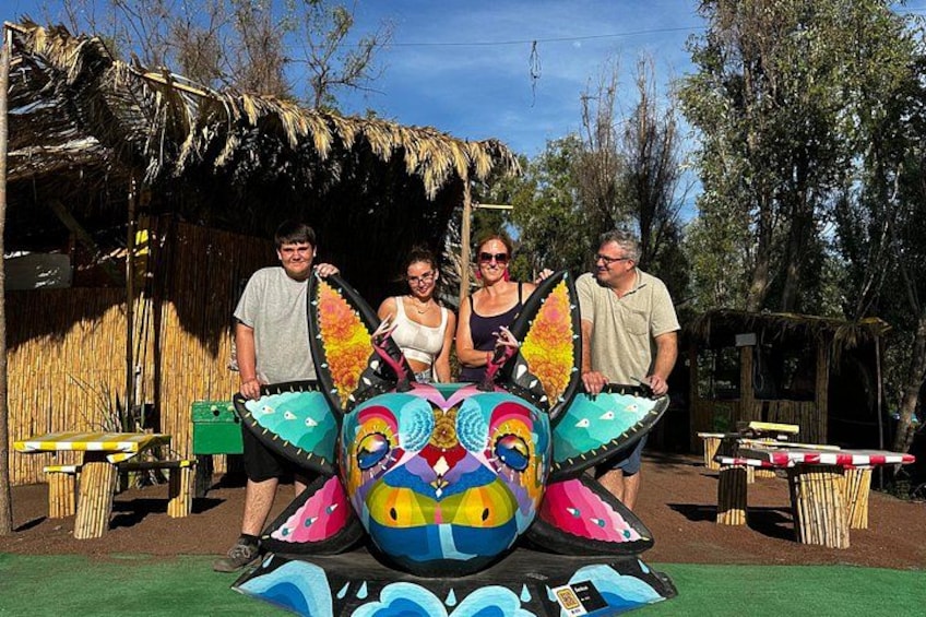 A colorful, cartoonish structure with people standing in front of it. 1