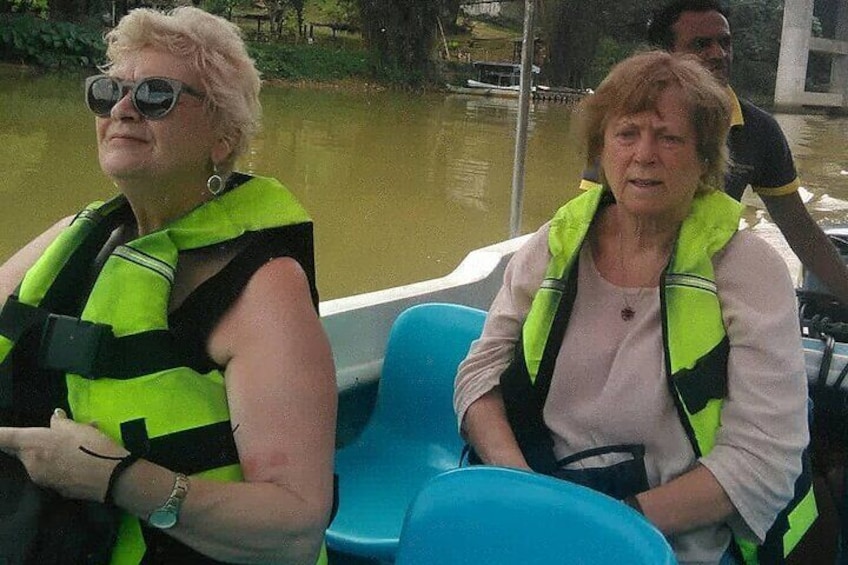 Two people wearing life jackets on a boat. 1