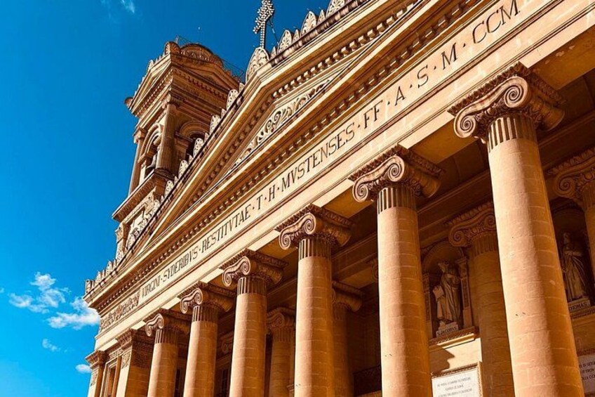 A classical building with ornate columns and detailed carvings. 4
