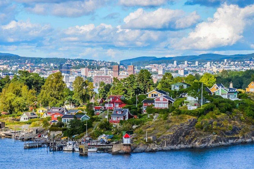 A coastal town with colorful houses, a harbor, and a cityscape in the background. 2