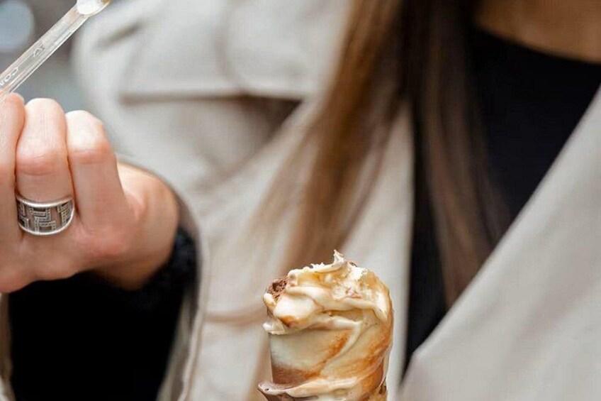 A person holding a cup of ice cream. 5