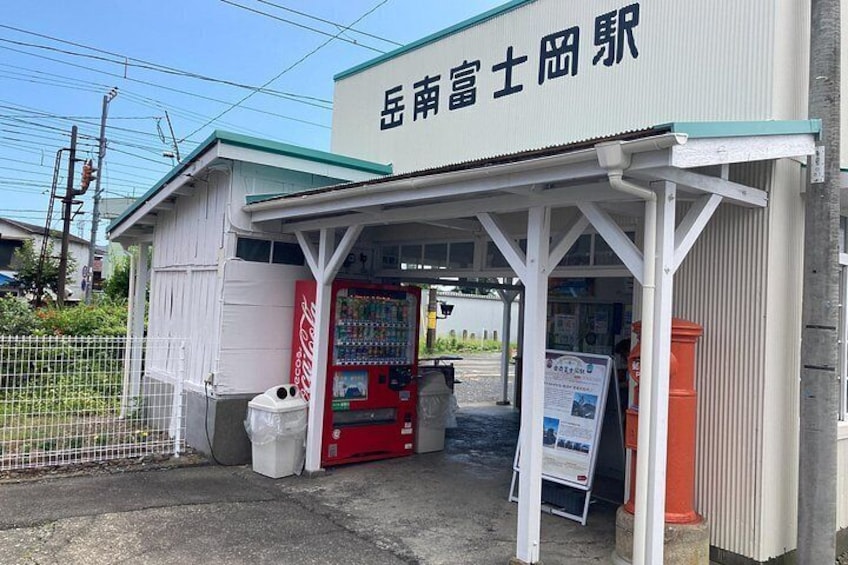 A small building with a Coca-Cola vending machine and a sign in Japanese. 4