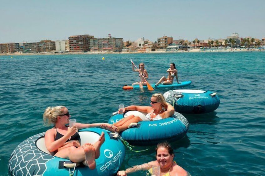People floating on water in inflatable rings. 2